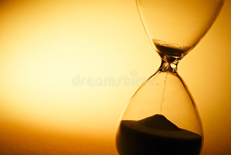 Sand passing through the bulbs of an hourglass