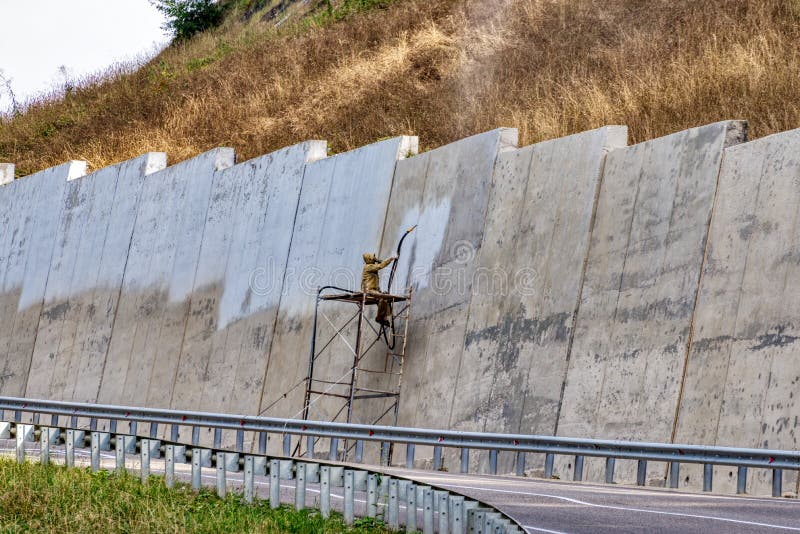 Sandblast Cleaning of a Concrete Protective Wall. Stock Photo Image
