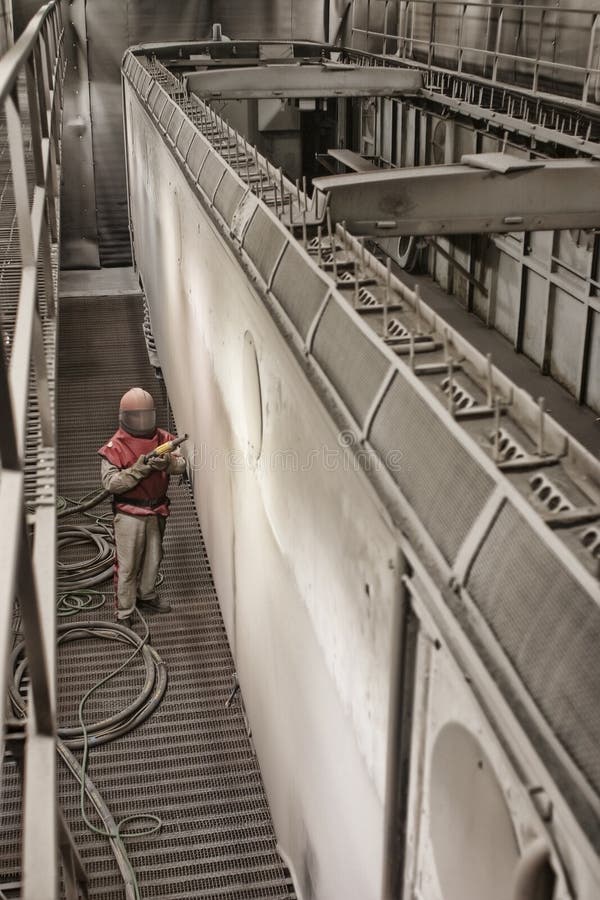 Sandblasting a train cart