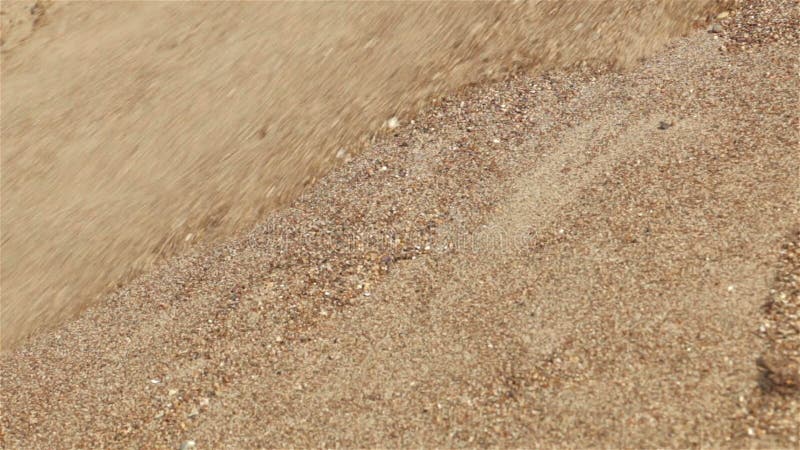 Sands on slope falling down. Close-up view background
