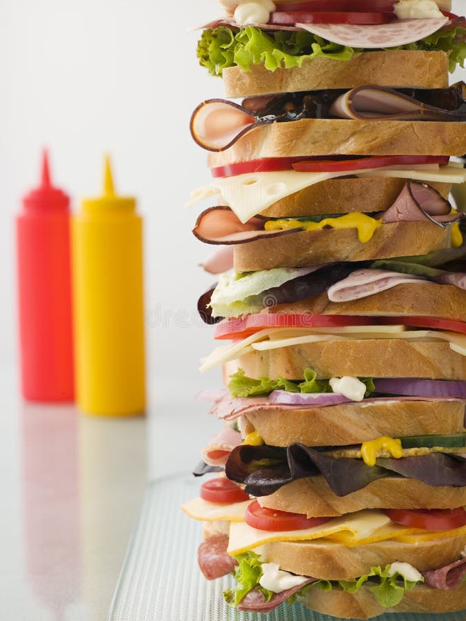 Dagwood Tower Sandwich With Sauce bottles in the background. Dagwood Tower Sandwich With Sauce bottles in the background