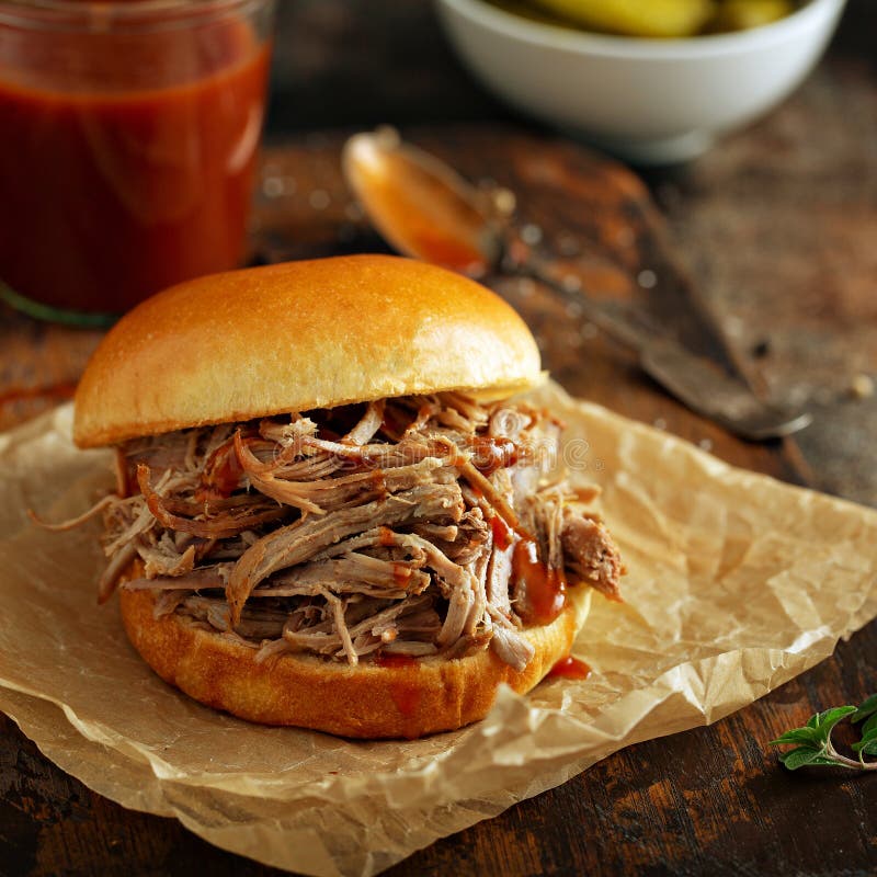 Pulled pork sandwich with brioche buns and pickles. Pulled pork sandwich with brioche buns and pickles