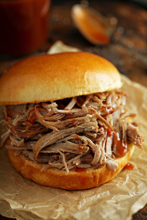 Pulled pork sandwich with brioche buns and pickles. Pulled pork sandwich with brioche buns and pickles