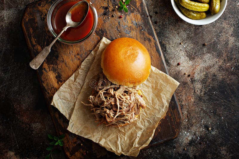 Pulled pork sandwich with brioche buns and pickles overhead view. Pulled pork sandwich with brioche buns and pickles overhead view