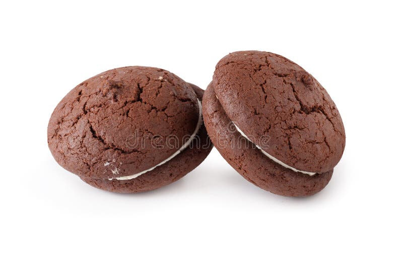 Sandwich chocolate cookies and cream on a white plate isolated over white background