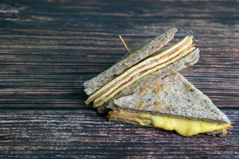 Sandwich ham cheese with Whole wheat Bread made from Riceberry on dark background royalty free stock photography Sandwich ham cheese with Whole wheat Bread made from Riceberry on dark background royalty free stock photography