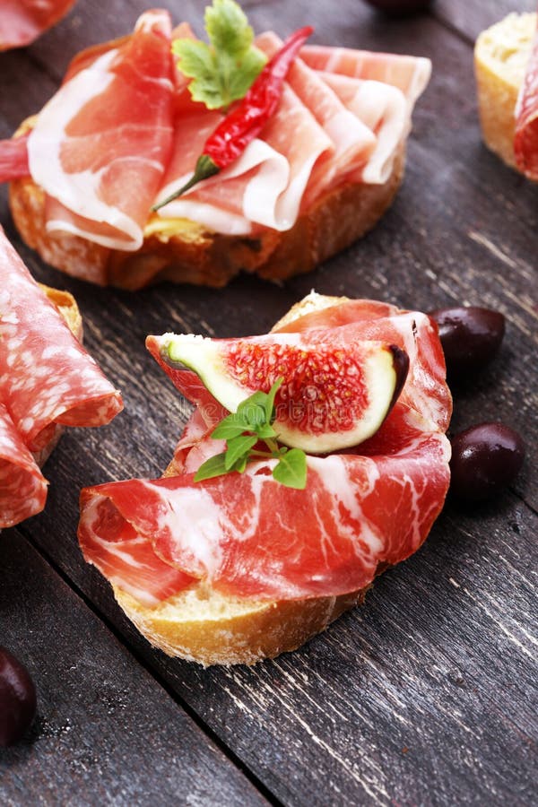 Sandwich with Prosciutto or Salami or Crudo. Antipasti Gourmet B Stock
