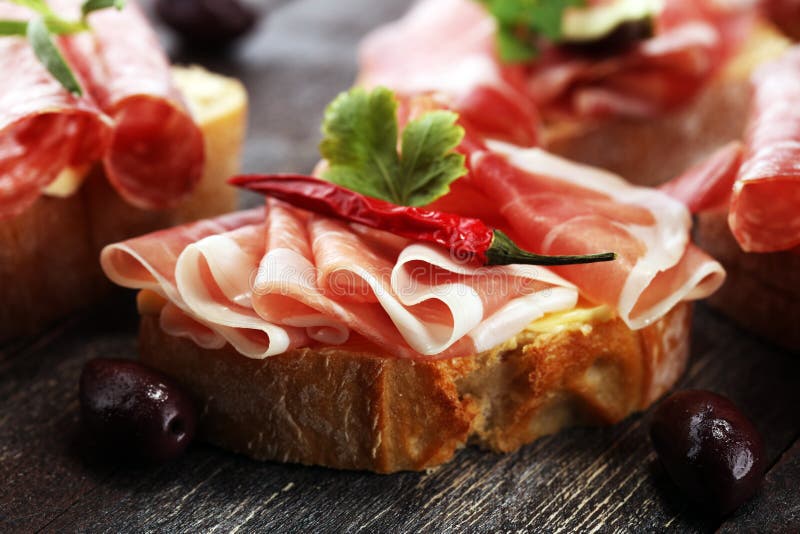 Sandwich with Prosciutto or Salami or Crudo. Antipasti Gourmet B Stock