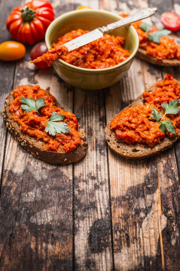 Sandwich with Tomatoes Paprika Spread on Rustic Wooden Background