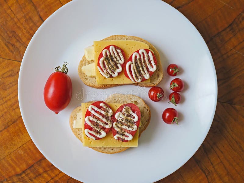 Sandwich with White Bread, Cheese, Tomato on a Plate and Small Baby