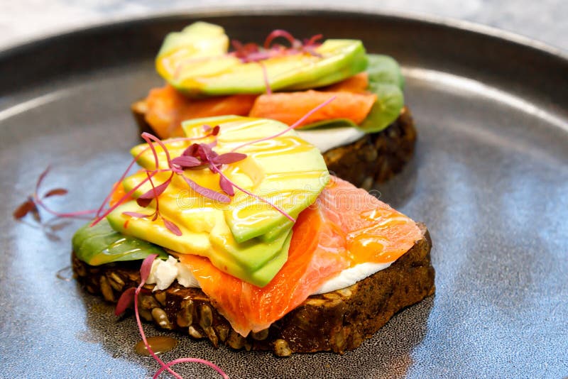 sandwiches with salmon grain bread cheese and avocado pieces. selective focus . High quality photo. sandwiches with salmon grain bread cheese and avocado pieces. selective focus . High quality photo