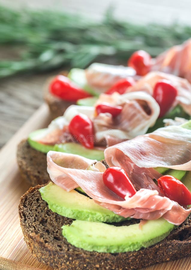Sandwiches with Avocado and Prosciutto Stock Photo Image of herb
