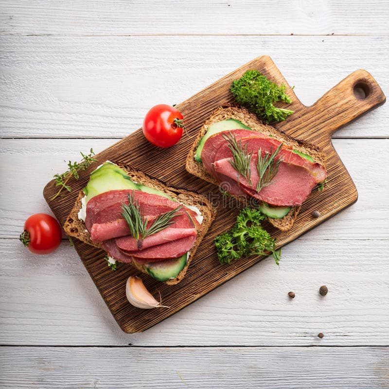 Sandwiches with beef, fresh vegetables and herbs on rustic wooden chopping board over white wood backdrop, top view. vector illustration