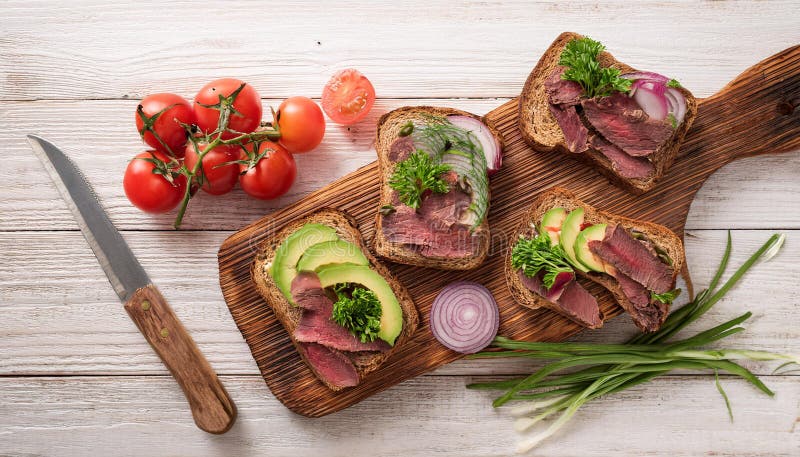 Sandwiches with beef, fresh vegetables and herbs on rustic wooden chopping board over white wood backdrop, top view. royalty free illustration
