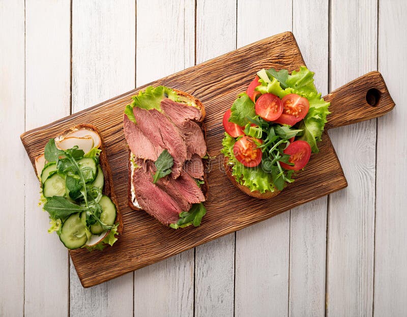 Sandwiches with beef, fresh vegetables and herbs on rustic wooden chopping board over white wood backdrop, top view. stock illustration