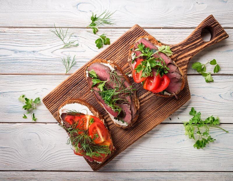 Sandwiches with beef, fresh vegetables and herbs on rustic wooden chopping board over white wood backdrop, top view. vector illustration