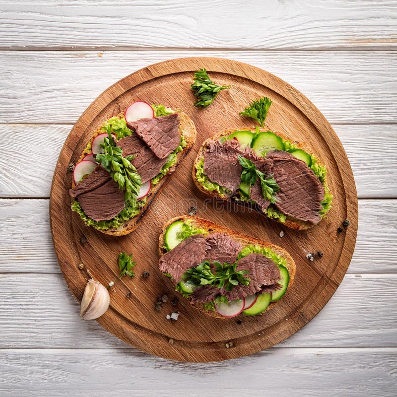 Sandwiches with beef, fresh vegetables and herbs on rustic wooden chopping board over white wood backdrop, top view. stock illustration