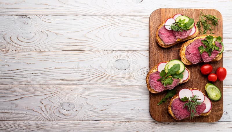 Sandwiches with beef, fresh vegetables and herbs on rustic wooden chopping board over white wood backdrop, top view. royalty free illustration