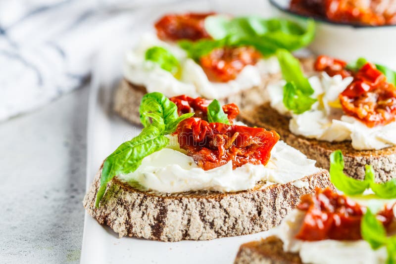 Sandwiches with Cottage Cheese and Sundried Tomatoes on White Board