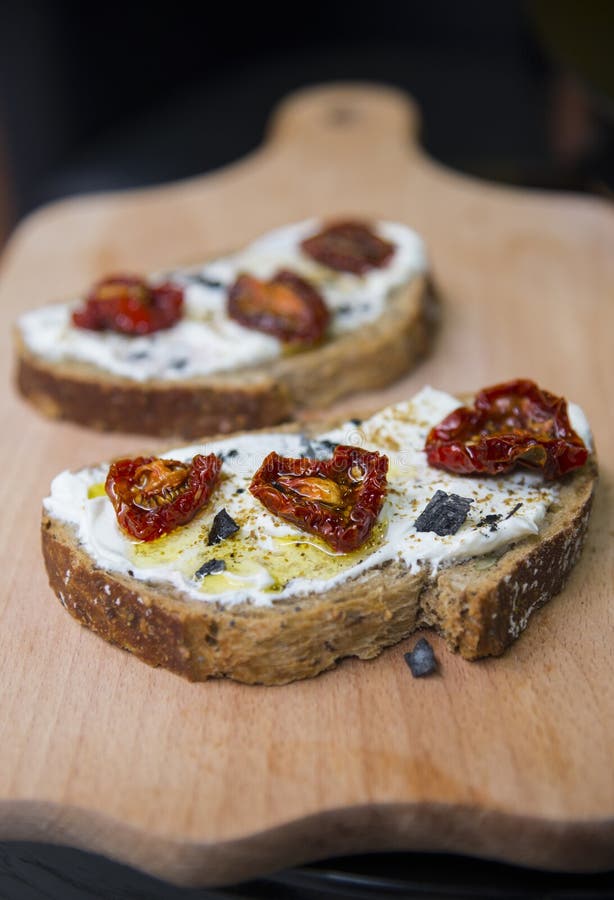 Sandwiches with dried tomatoes and black salt