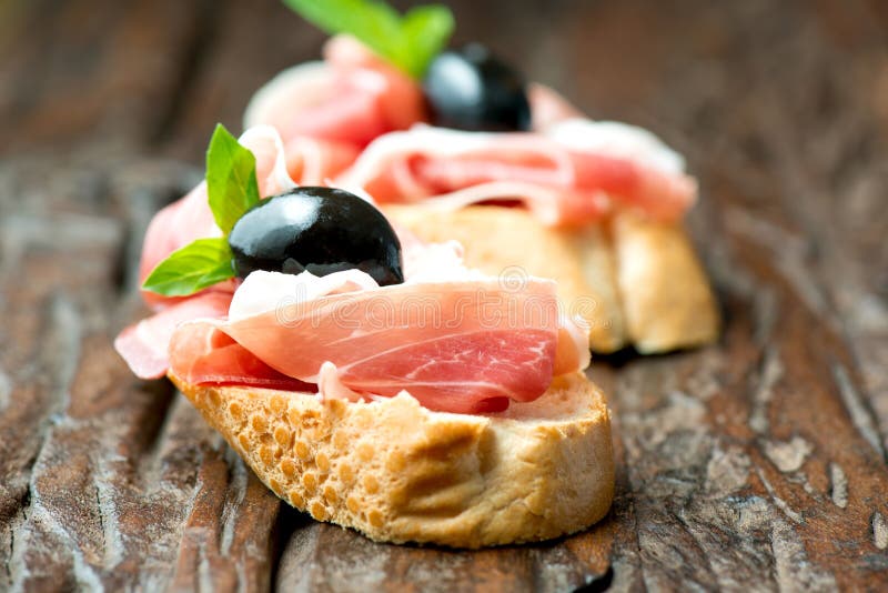 Sandwiches with prosciutto olive on wooden old table horizontal royalty free stock image Sandwiches with prosciutto olive on wooden old table horizontal royalty free stock image