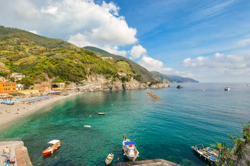 The sandy beach at Monterosso al Mare, Cinque Terre Italy with boats in the sea and the coastline stretching behind. stock images The sandy beach at Monterosso al Mare, Cinque Terre Italy with boats in the sea and the coastline stretching behind. stock images