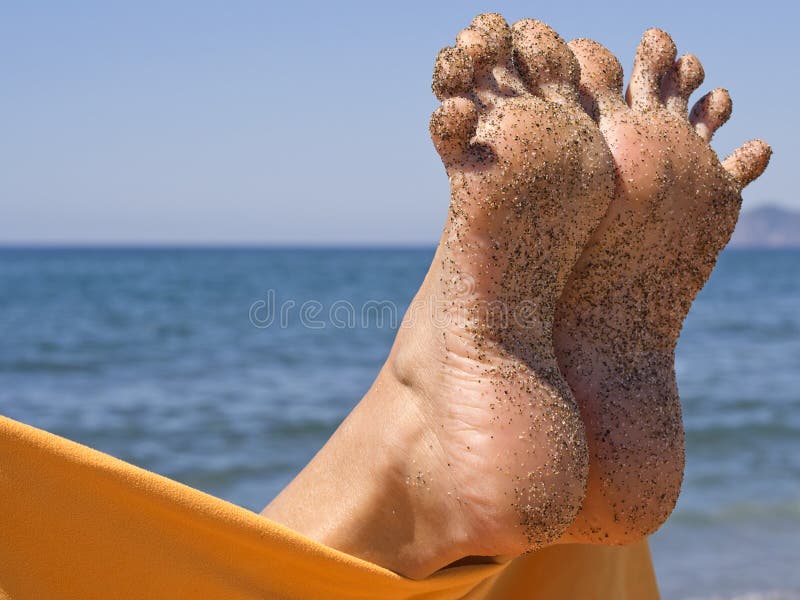 Sandy crazy woman toes moving and relaxing on the beach. Sandy crazy woman toes moving and relaxing on the beach