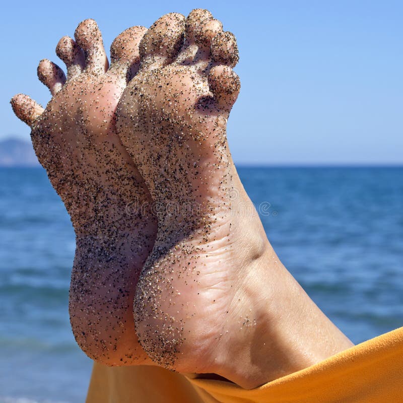 Sandy crazy woman toes moving and relaxing on the beach. Sandy crazy woman toes moving and relaxing on the beach