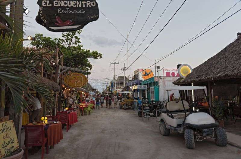 Sandy road with tourists and stalls on holbox island, quintana r