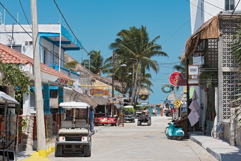 Sandy road with tourists and stalls on Holbox Island, Quintana R