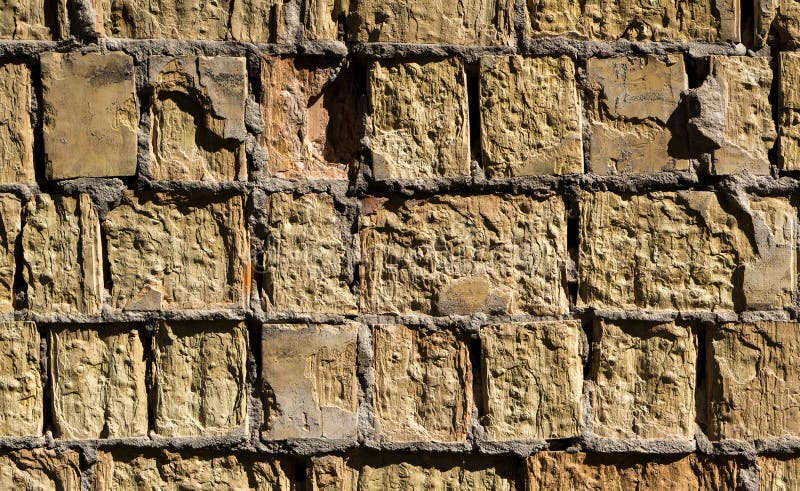 Sandy stone brick wall detailed texture stock photos