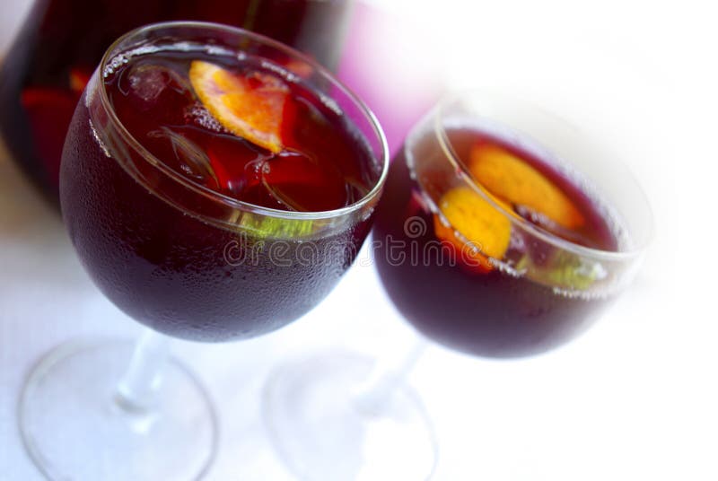 Two glass cups filled with fresh tasty sangria. Two glass cups filled with fresh tasty sangria