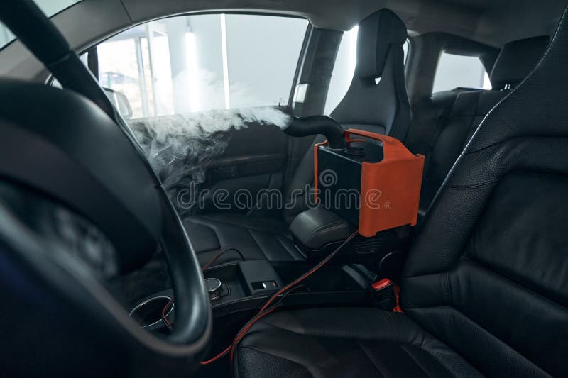 Sanitizing Clean of Car Interior. Steering Wheel and Seats Disinfection
