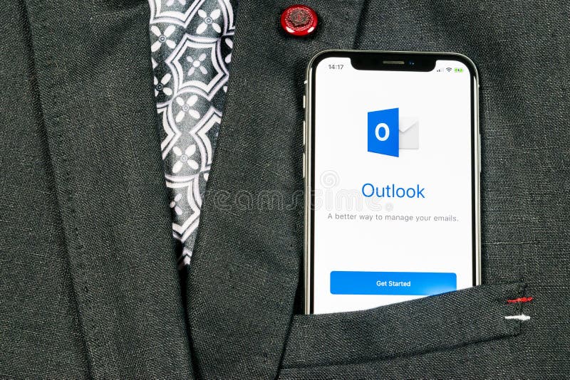 Microsoft Outlook office application icon on Apple iPhone X screen close-up in jacket pocket. Microsoft outlook app icon. Microsof