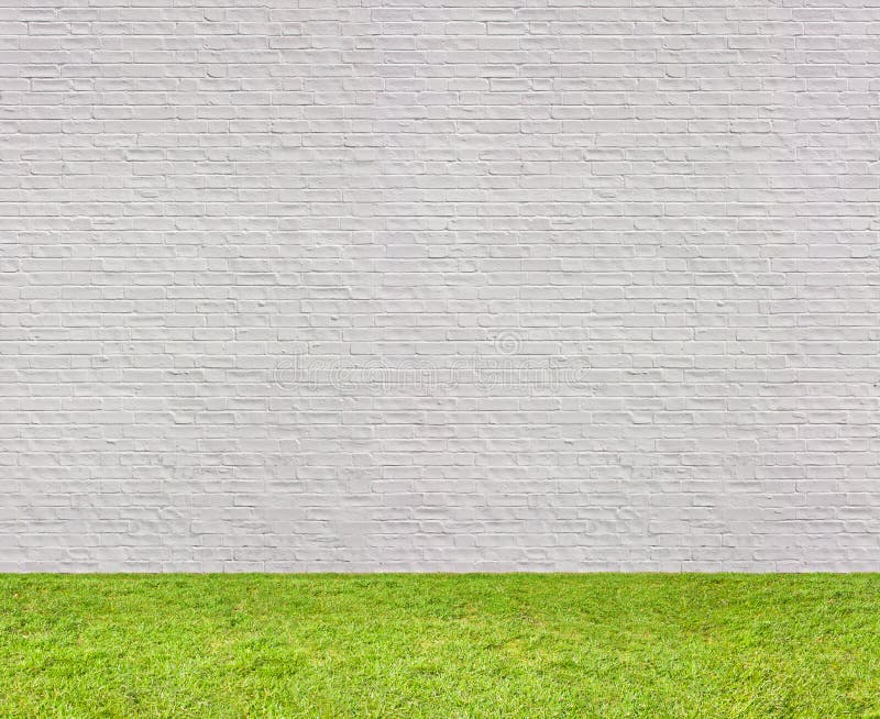 Sans couture horizontal de mur de briques blanc avec la pelouse photos stock Sans couture horizontal de mur de briques blanc avec la pelouse photos stock
