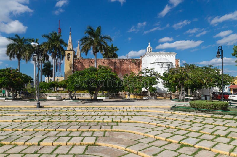 Santa Ana park and church with tropical trees, Merida, Yucatan, Mexico