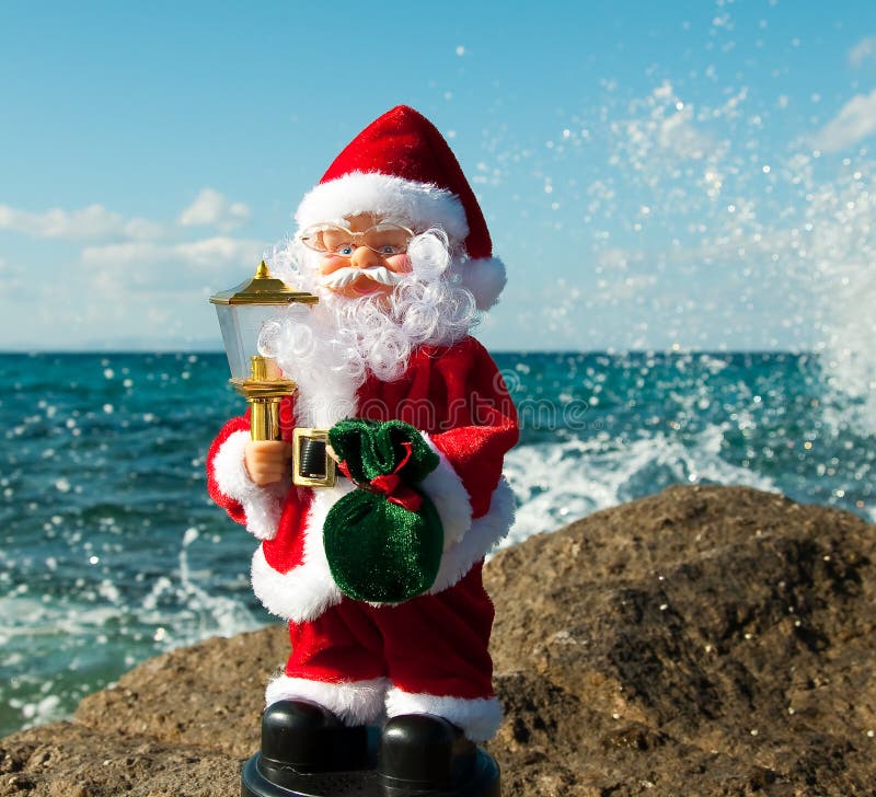 Santa Claus with gifts in a spray of sea waves