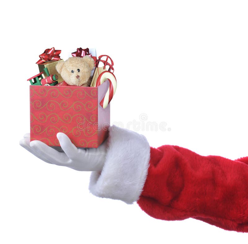 Santa Claus hand holding out an gift box filled with toys and candy canes.