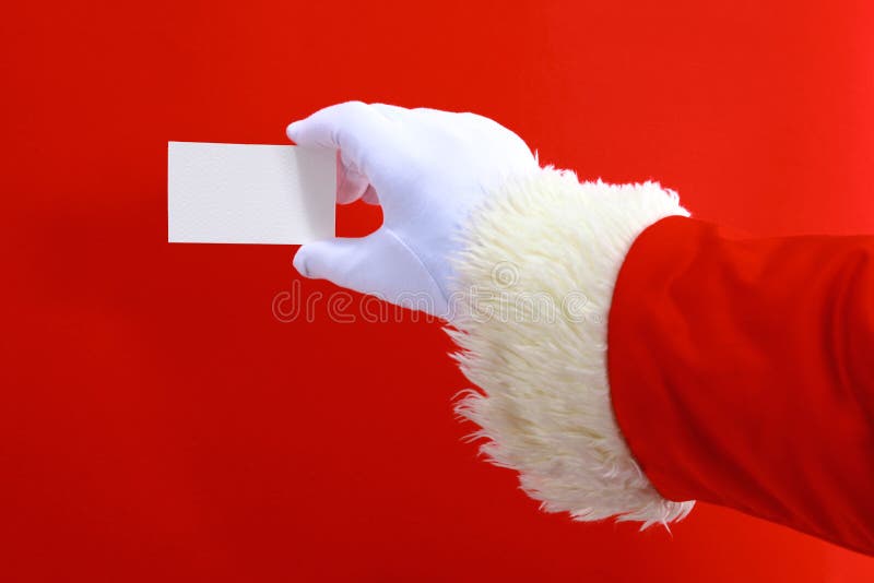 Santa Claus hand presenting your christmas text or product over red background with copy space