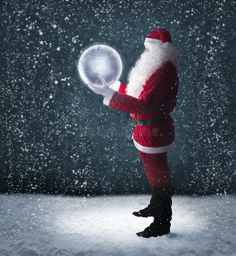 Santa Claus holding glowing planet earth