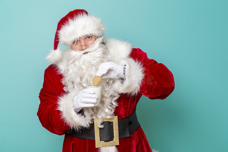Santa Claus holding milk and cookies royalty free stock photo Santa Claus holding milk and cookies royalty free stock photo
