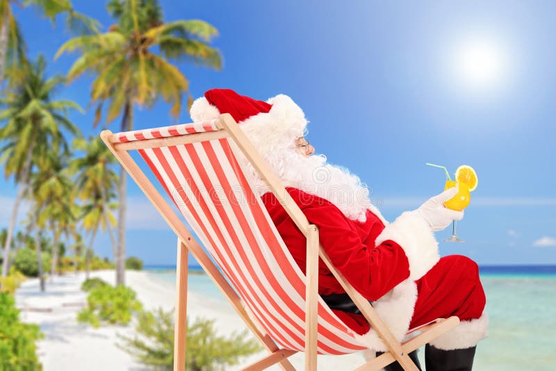 Santa Claus lying on a chair and drinking orange cocktail stock image Santa Claus lying on a chair and drinking orange cocktail stock image