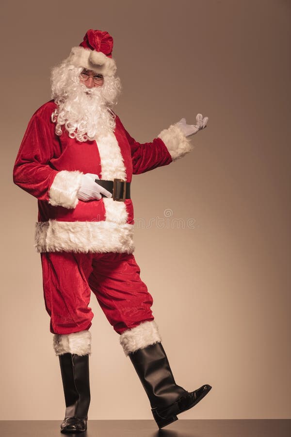 Santa Claus presenting something on his left royalty free stock photo Santa Claus presenting something on his left royalty free stock photo