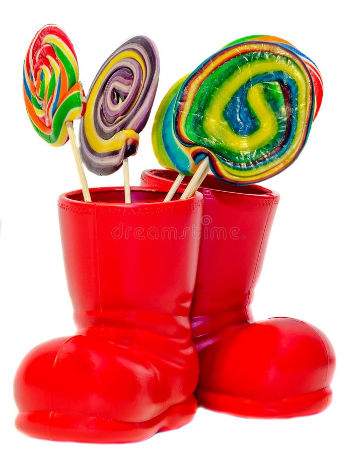 Santa Claus red boot, shoe with colored sweet lollipops, candys. Saint Nicholas boot with presents gifts.