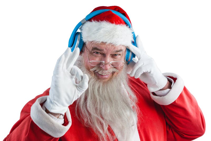 Santa Claus seansu ręki ok znak podczas gdy słuchający muzyka na hełmofonach zdjęcia stock Santa Claus seansu ręki ok znak podczas gdy słuchający muzyka na hełmofonach zdjęcia stock