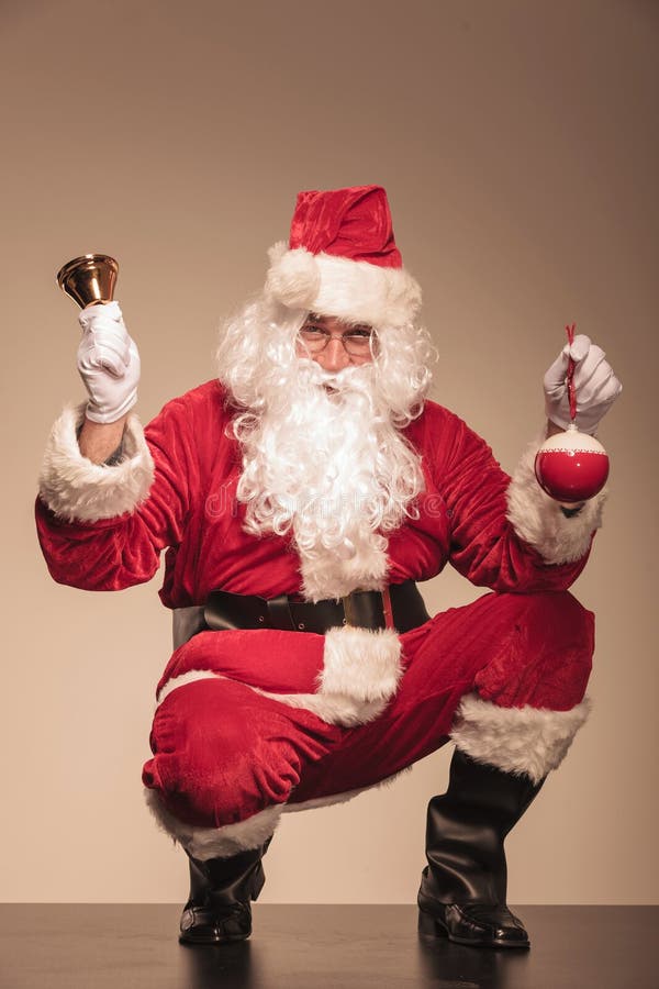 Santa CLaus sitting with a bell in his left hand stock photos Santa CLaus sitting with a bell in his left hand stock photos