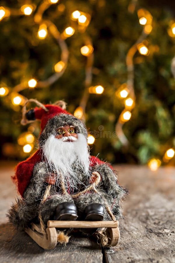 Santa Claus on a Sledge on the Background of Christmas Lights Stock