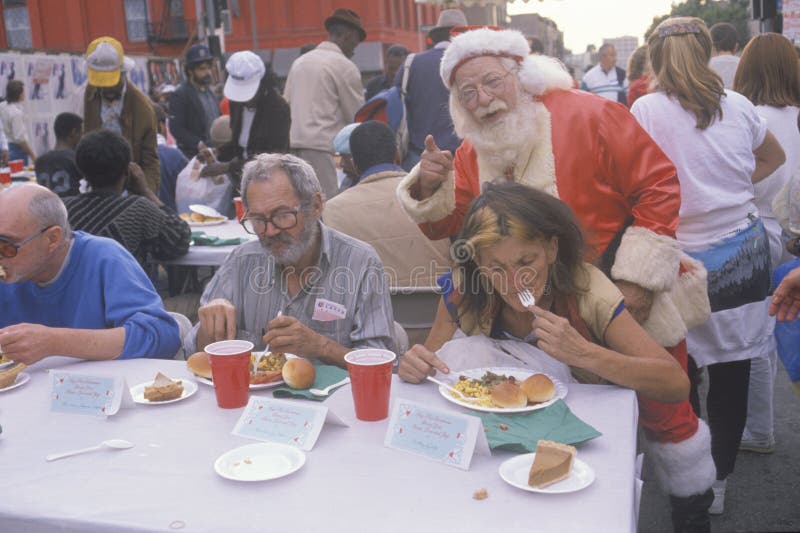 Santa Claus posing with the homeless for Christmas dinner, Los Angeles, California. Santa Claus posing with the homeless for Christmas dinner, Los Angeles, California