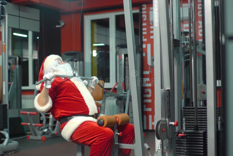 Santa Claus Training at the Gym on Christmas Day. Exercisemachine
