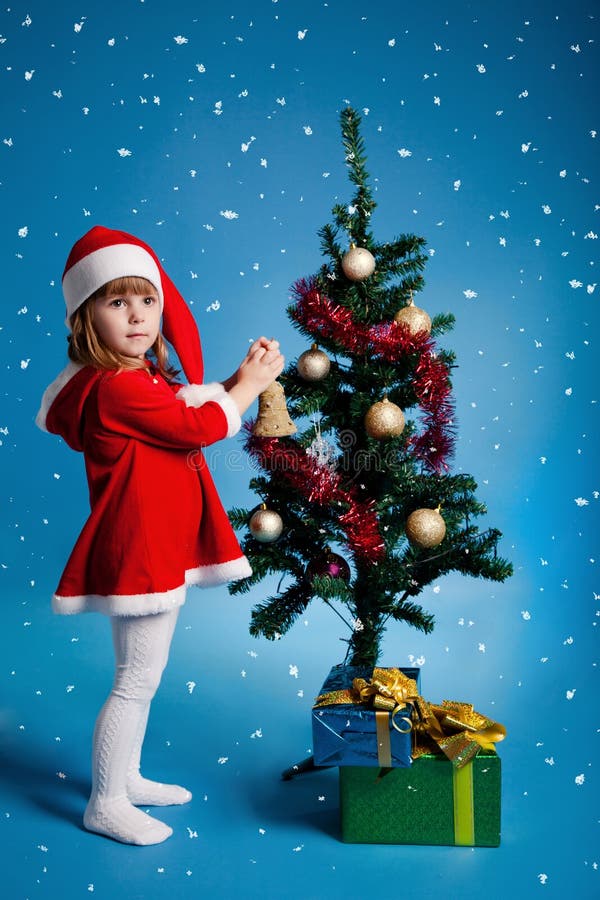 Santa girl decorating Christmas tree